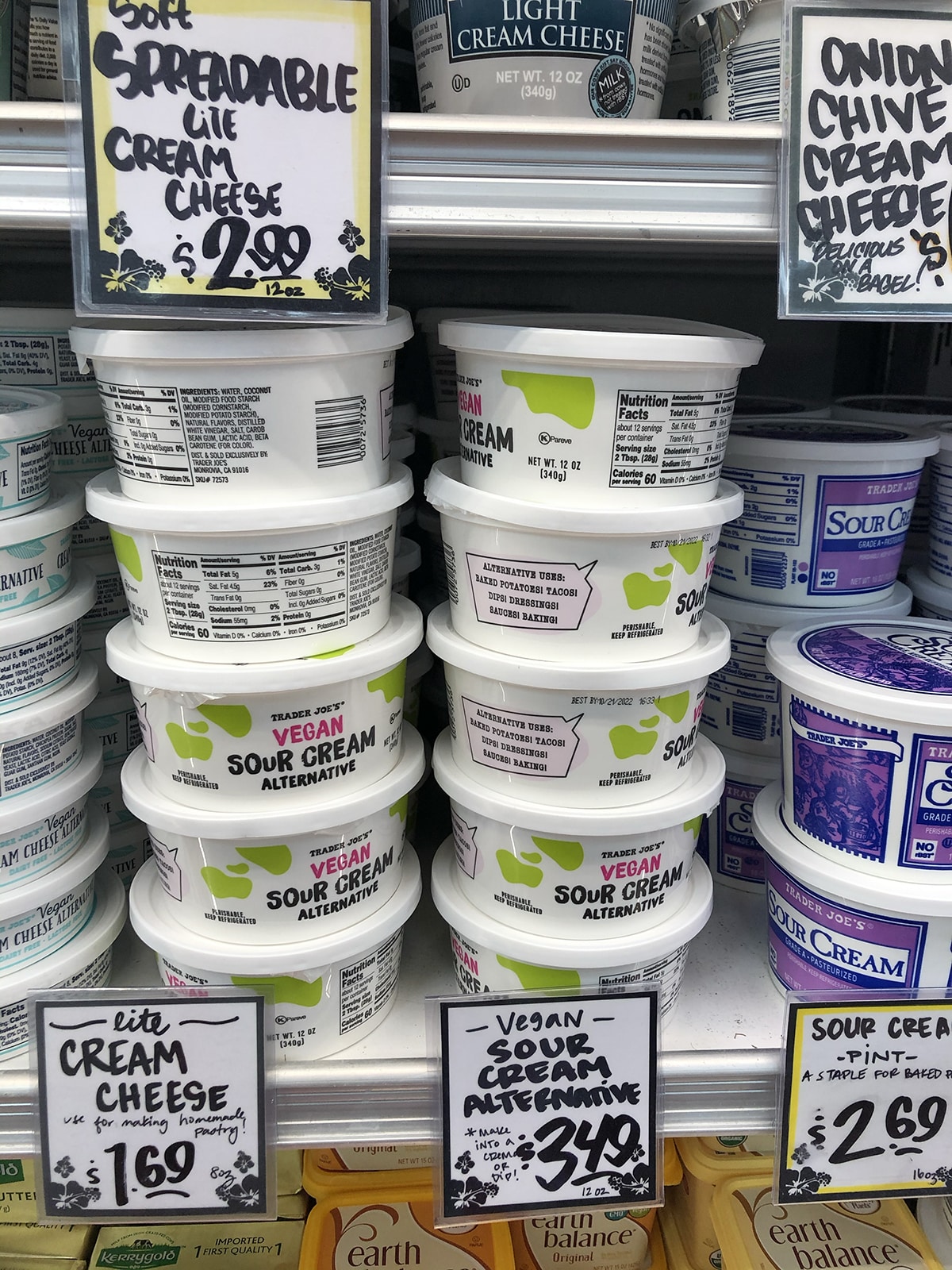 Vegan sour cream alternative stacked in refrigerated case at Trader Joe's.