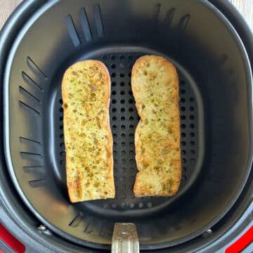 Easy air fryer garlic bread in air fryer basket.