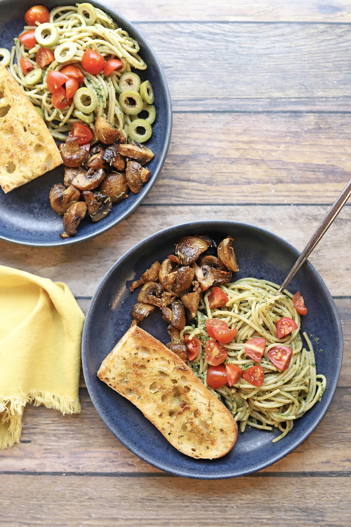 Bowls of pasta, air fryer garlic bread, and air fried mushrooms.