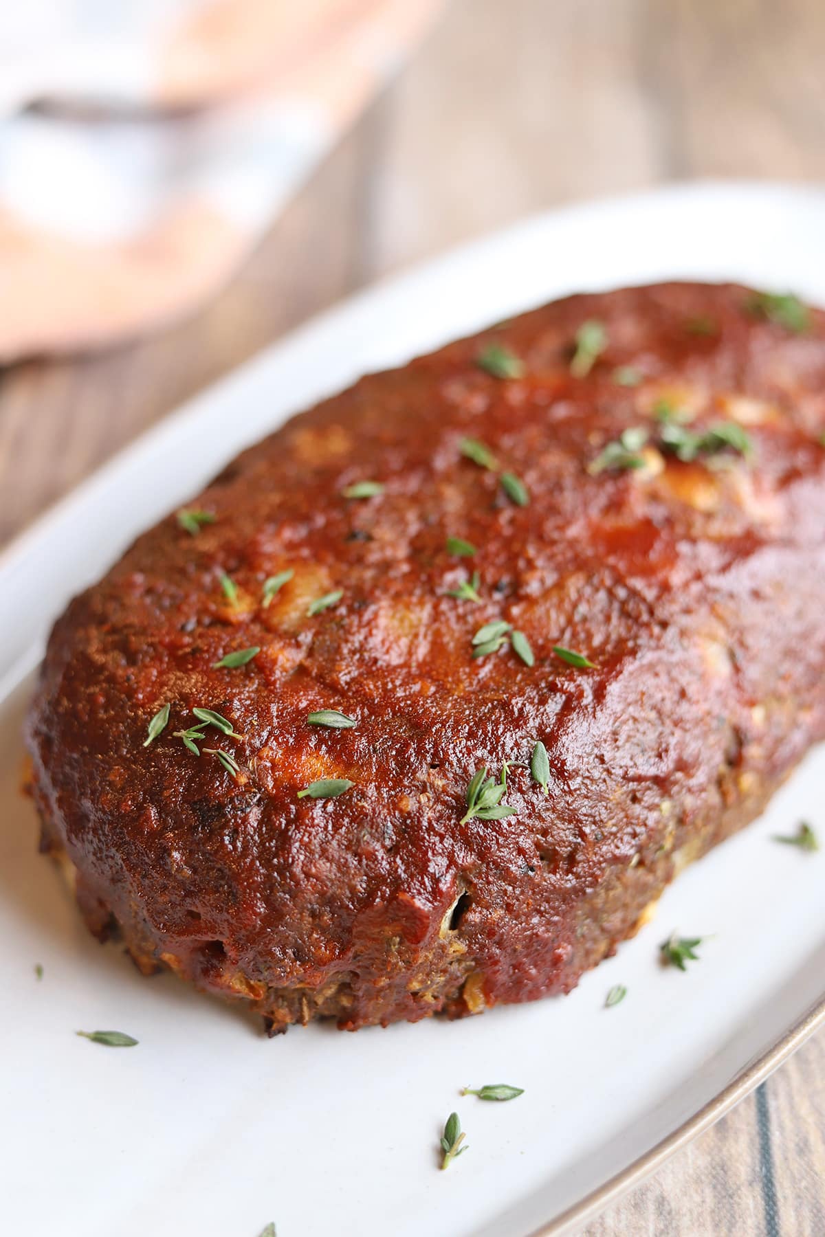 Glistening tomato ketchup glaze on vegan meatloaf.
