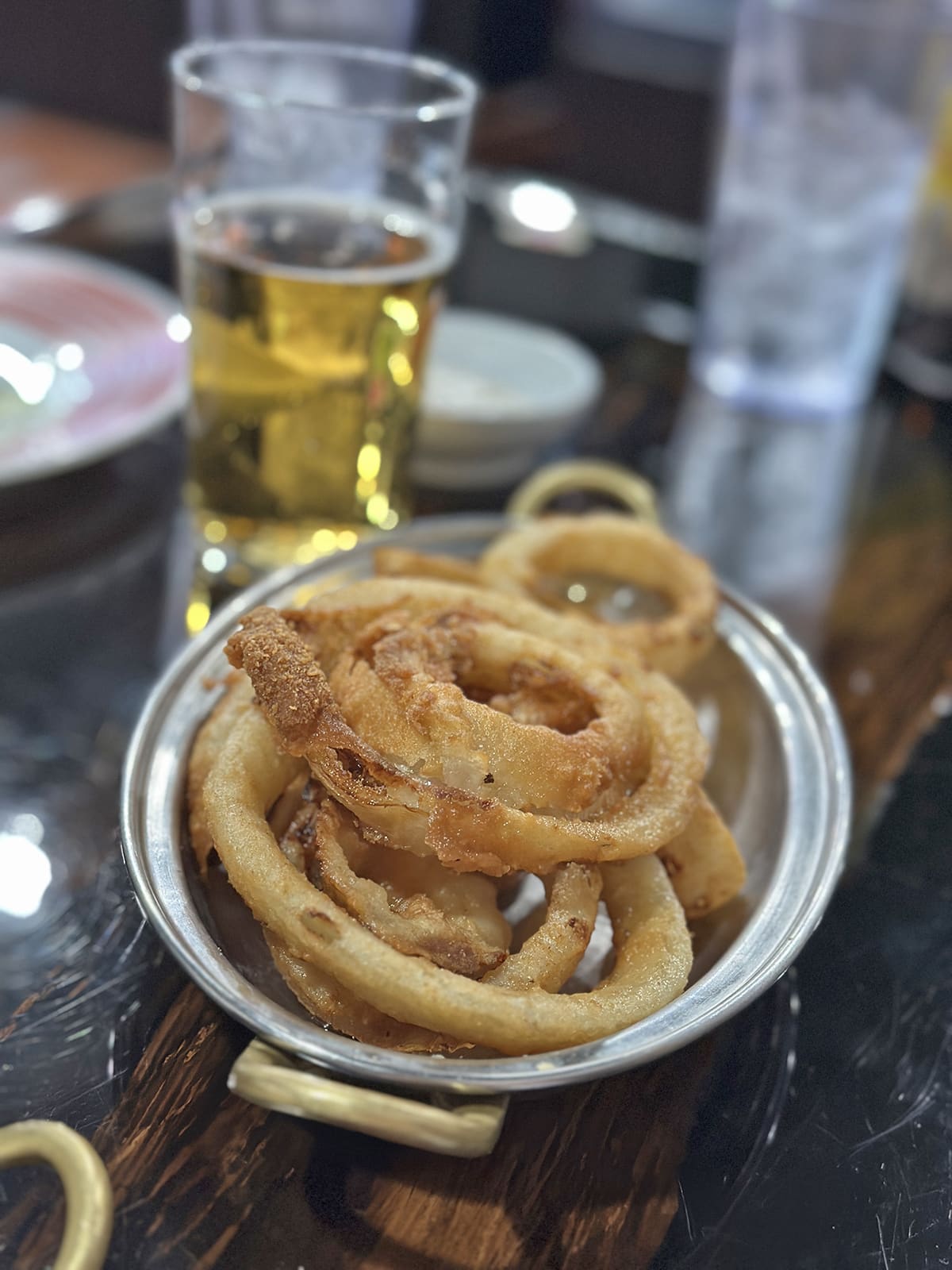 Onion rings in small metal tray.