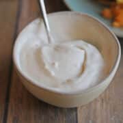 Vegan sour cream in white bowl.