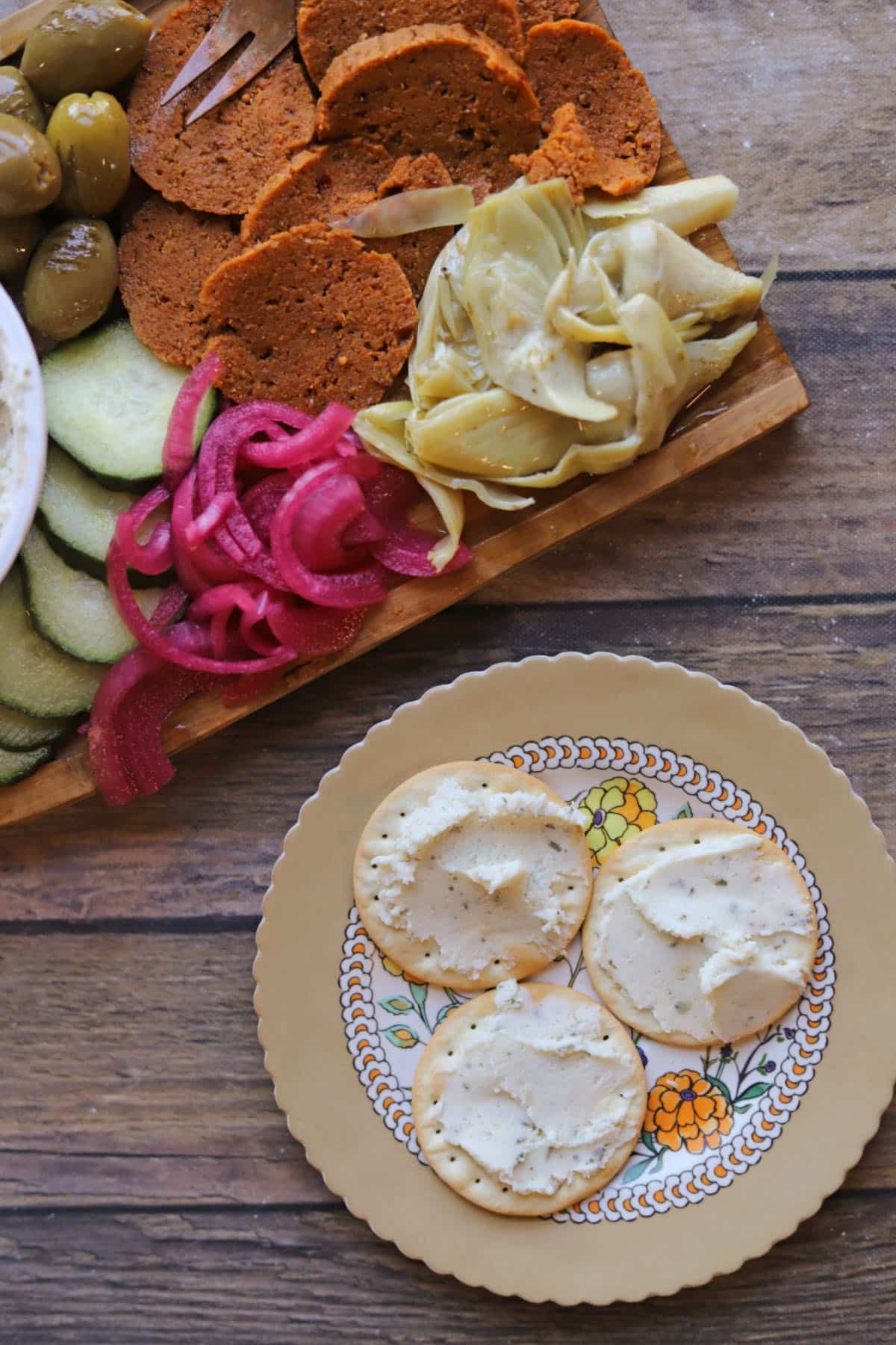 Boursin vegan garlic cheese spread on crackers by vegan charcuterie board.
