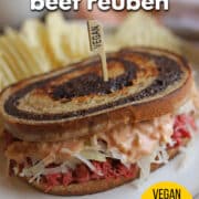 Text overlay: Jackfruit corned beef reuben, vegan deli sandwich, cadryskitchen.com. Jackfruit reuben with vegan Thousand Island and sauerkraut on plate.