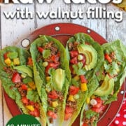 Text overlay: Raw tacos with walnut filling, 12-minute recipe, cadryskitchen.com. Raw vegan tacos on platter with avocado, bell pepper, and tomatoes.