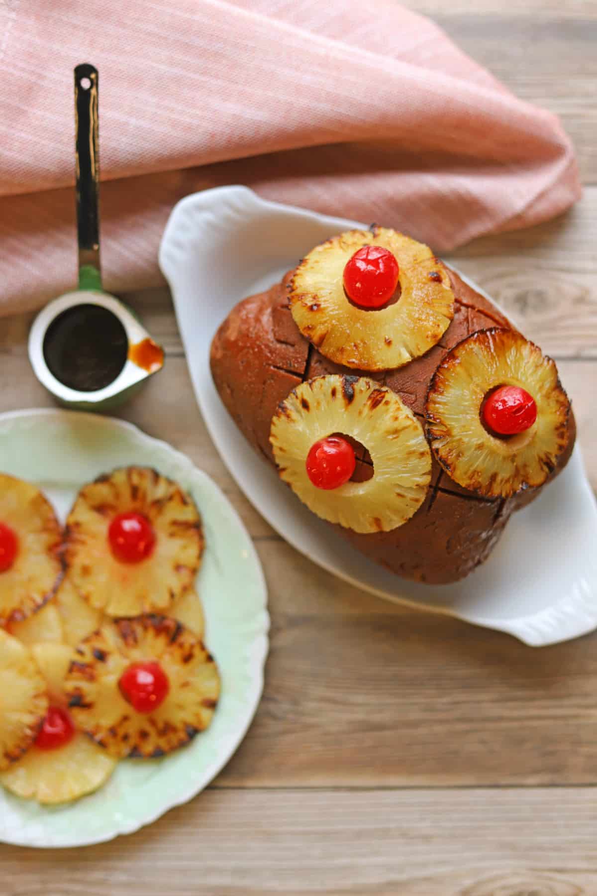 Seitan ham roast on table with caramelized pineapple rings and pineapple brown sugar glaze.
