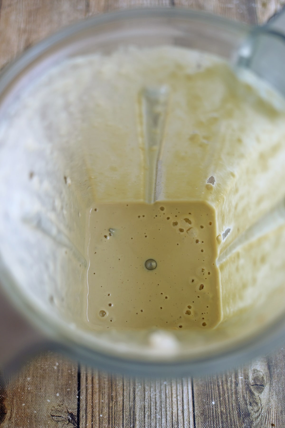 Creamy cashew dressing with cilantro in blender pitcher.