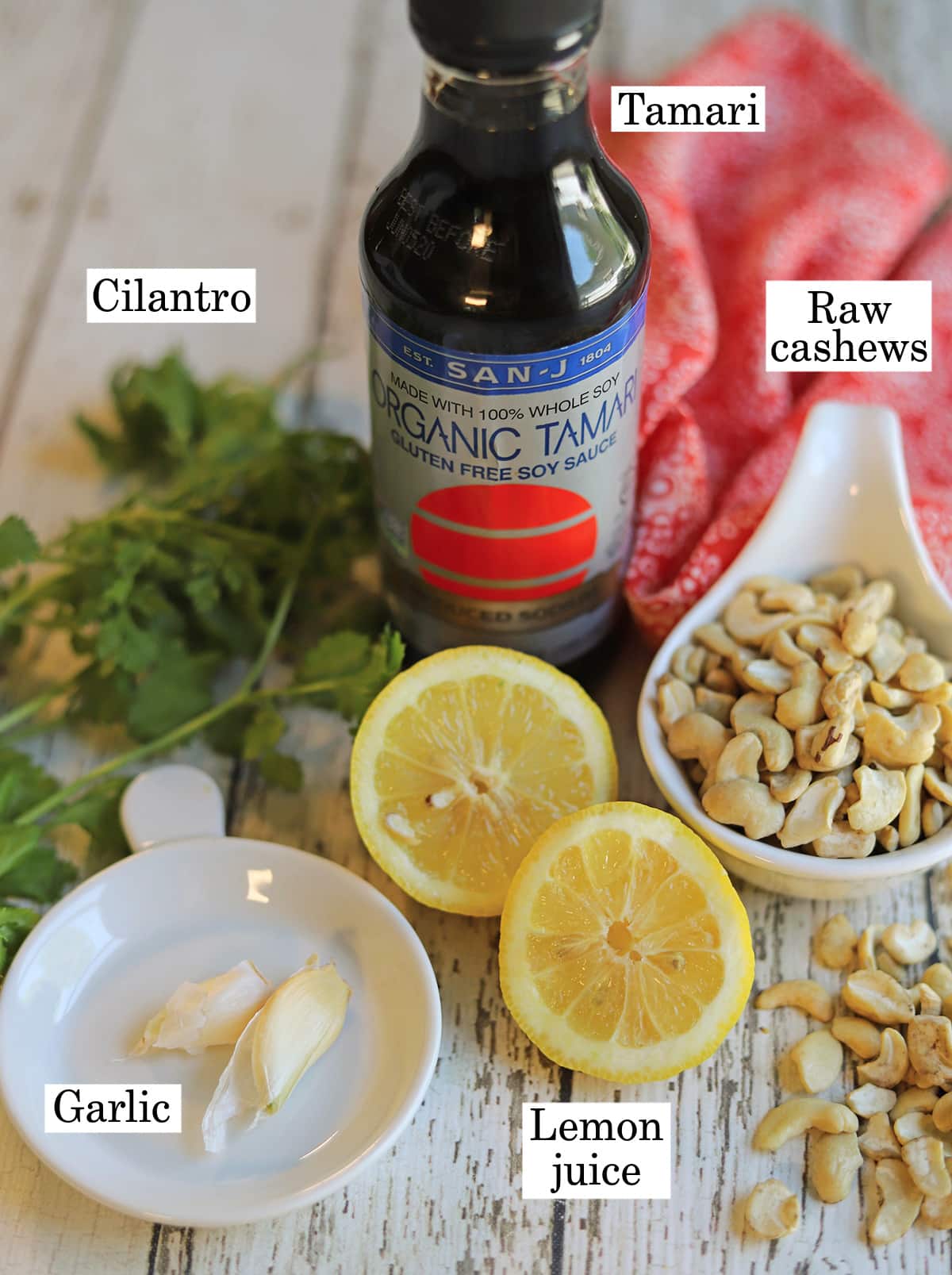 Labeled ingredients for vegan cashew dressing with cilantro, tamari, garlic, lemon juice, and tamari.