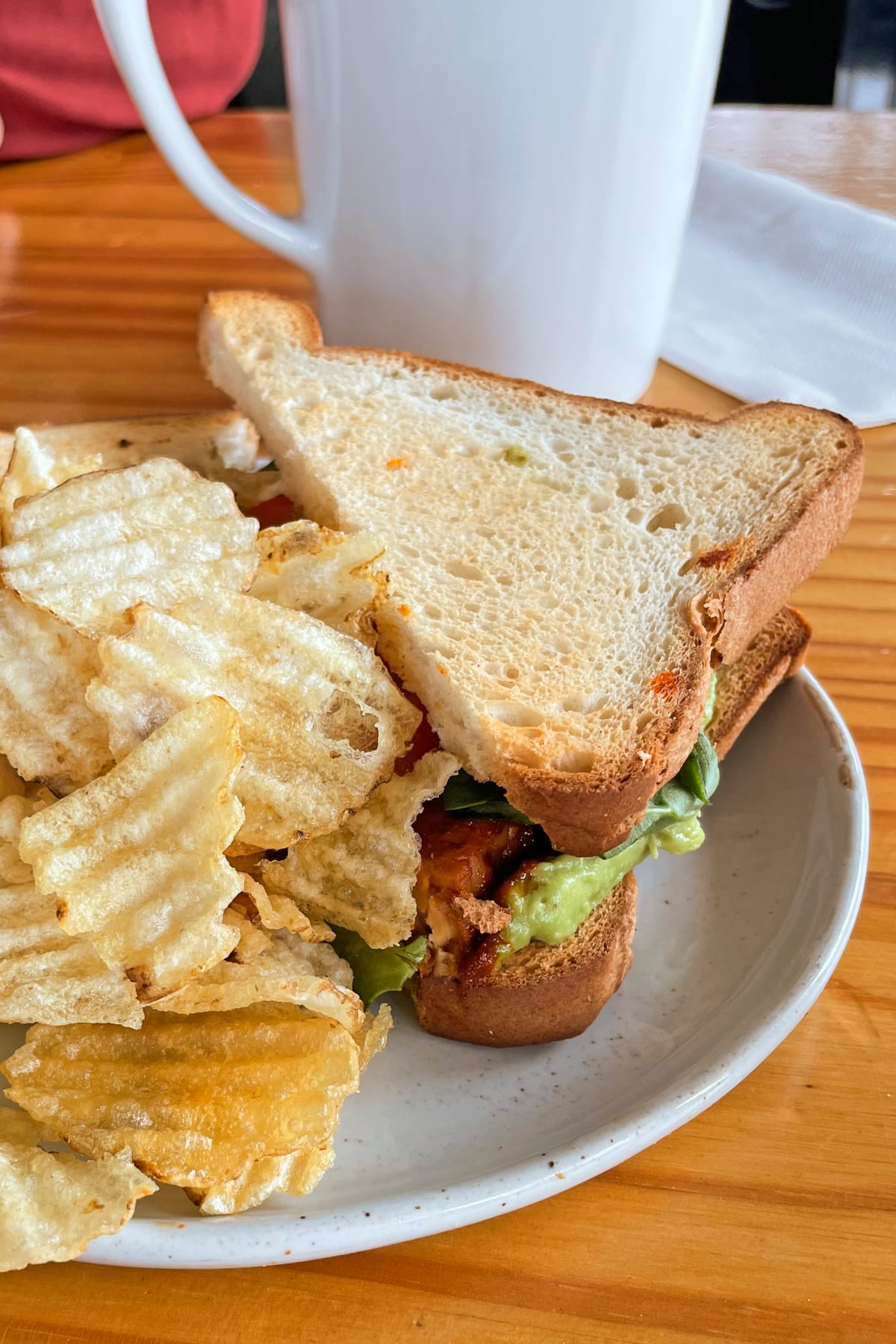 Vegan BLTA sandwich with potato chips at Kindred Coffee in Iowa City, Iowa.