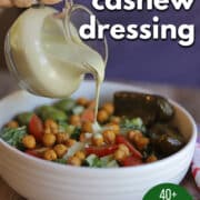 Text overlay: Creamy cashew dressing, 40+ 5-star ratings, cadryskitchen.com. Oil-free dressing being poured onto salad.