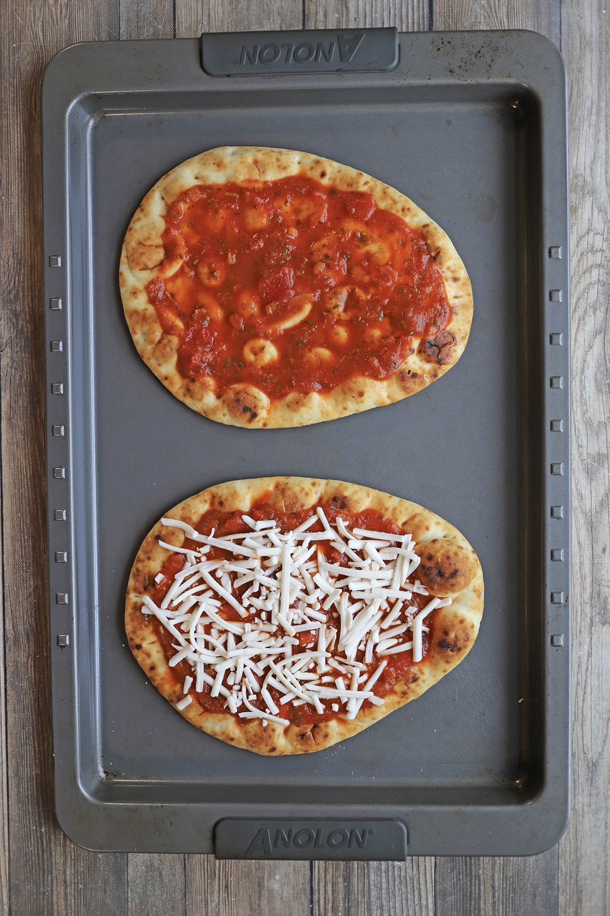 Flatbread topped with sausage and vegan mozzarella.