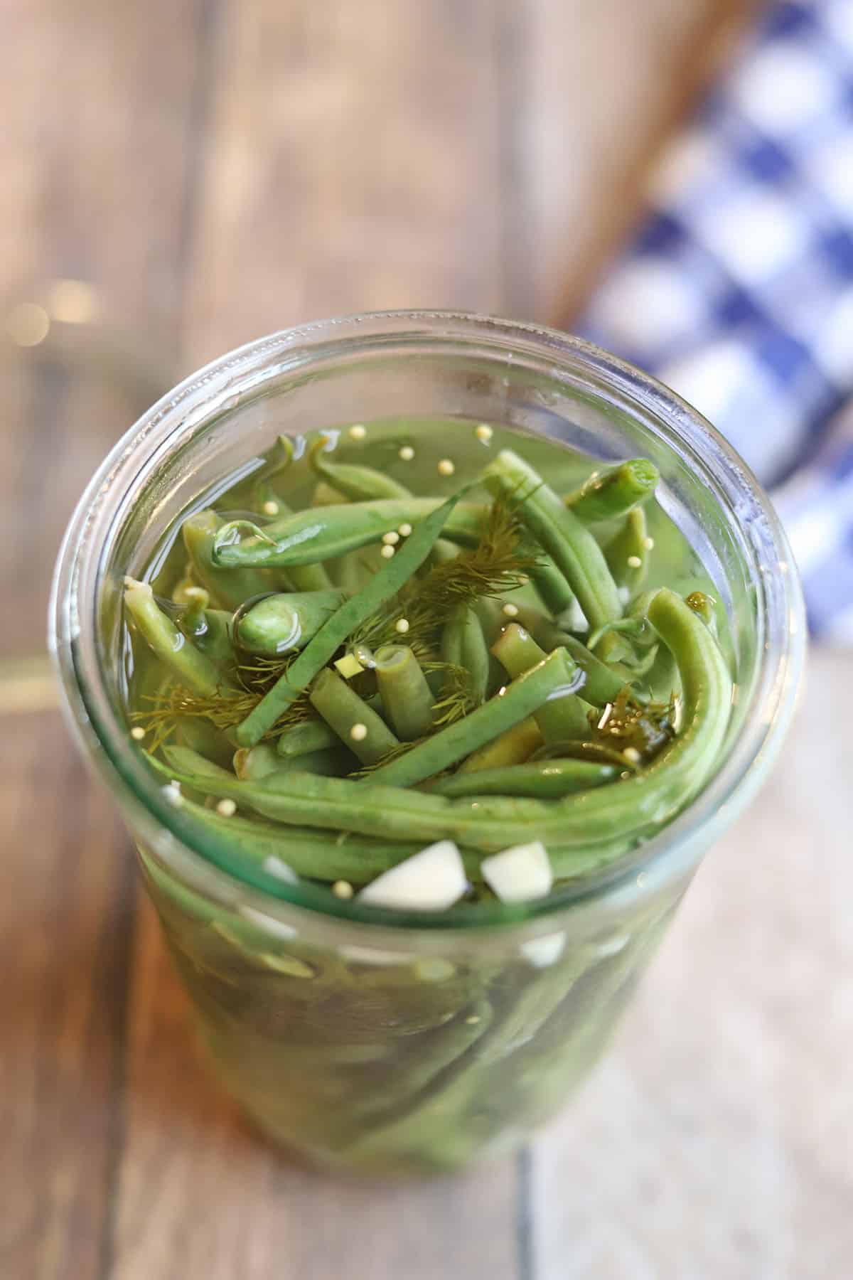 Crunchy green bean pickles in jar.