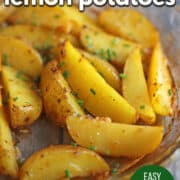 Text overlay: Roasted Greek lemon potatoes, easy vegan side dish, cadryskitchen.com. Roasted potato wedges in baking dish, garnished with chives.