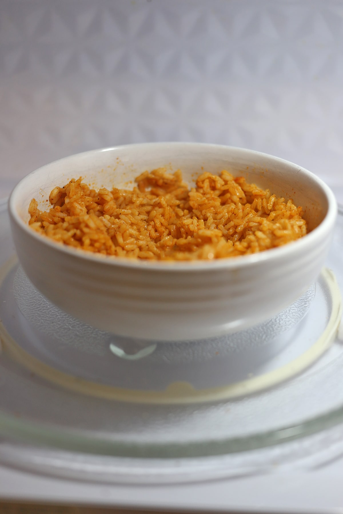 Trader Joe's frozen Spanish style rice in bowl in microwave.