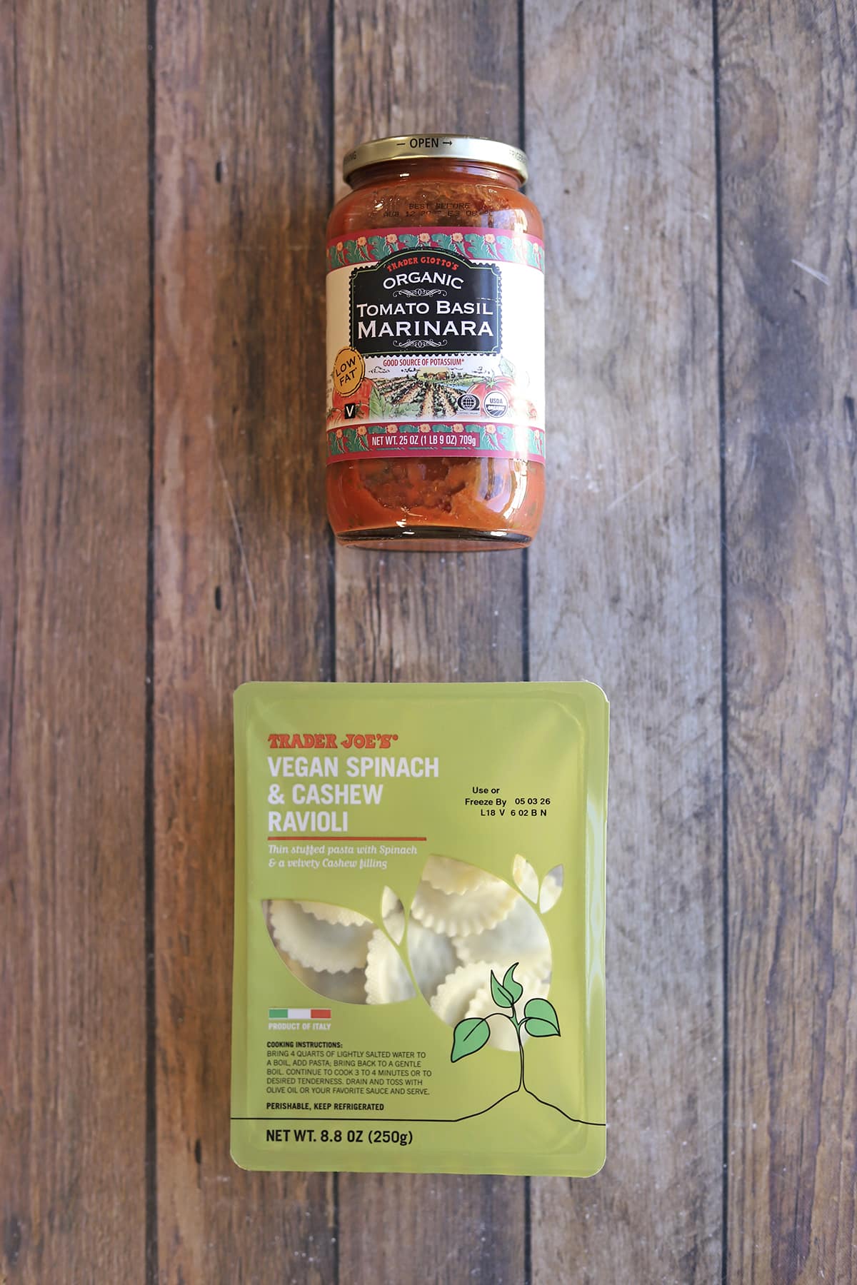 Package of Trader Joe's vegan spinach and cashew ravioli and jar of organic tomato basil marinara.