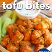 Text overlay: Buffalo tofu bites, air fryer, oven baked, pan fried, cadryskitchen.com. Platter of crispy buffalo tofu bites with celery sticks and creamy dipping sauce.