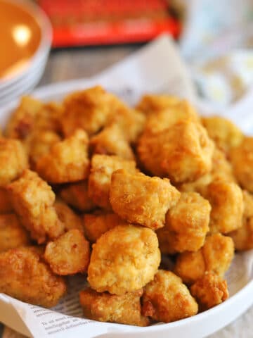 Crispy air fryer tofu nuggets on plate lined with paper.