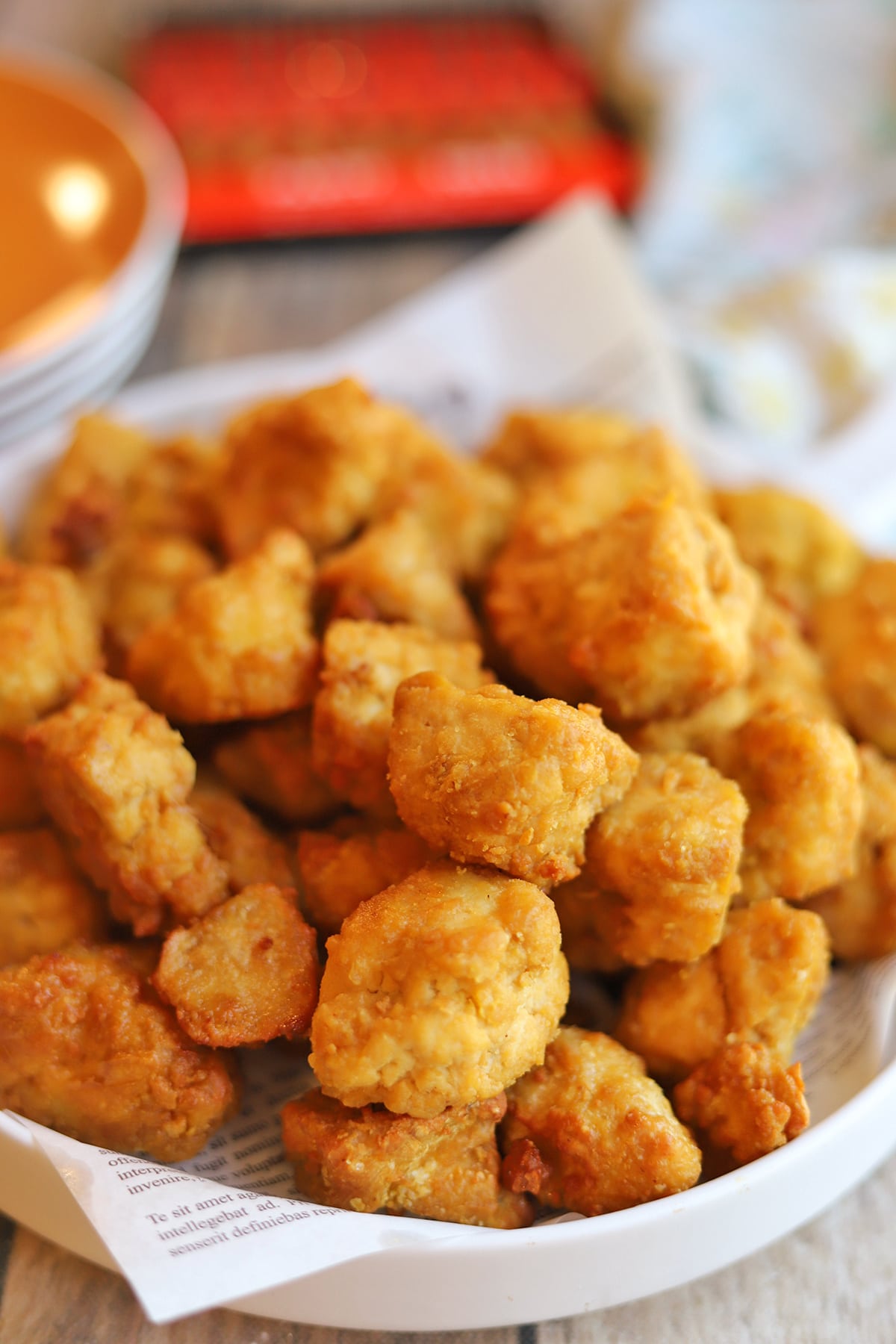 Crispy air fryer tofu nuggets on plate lined with paper.