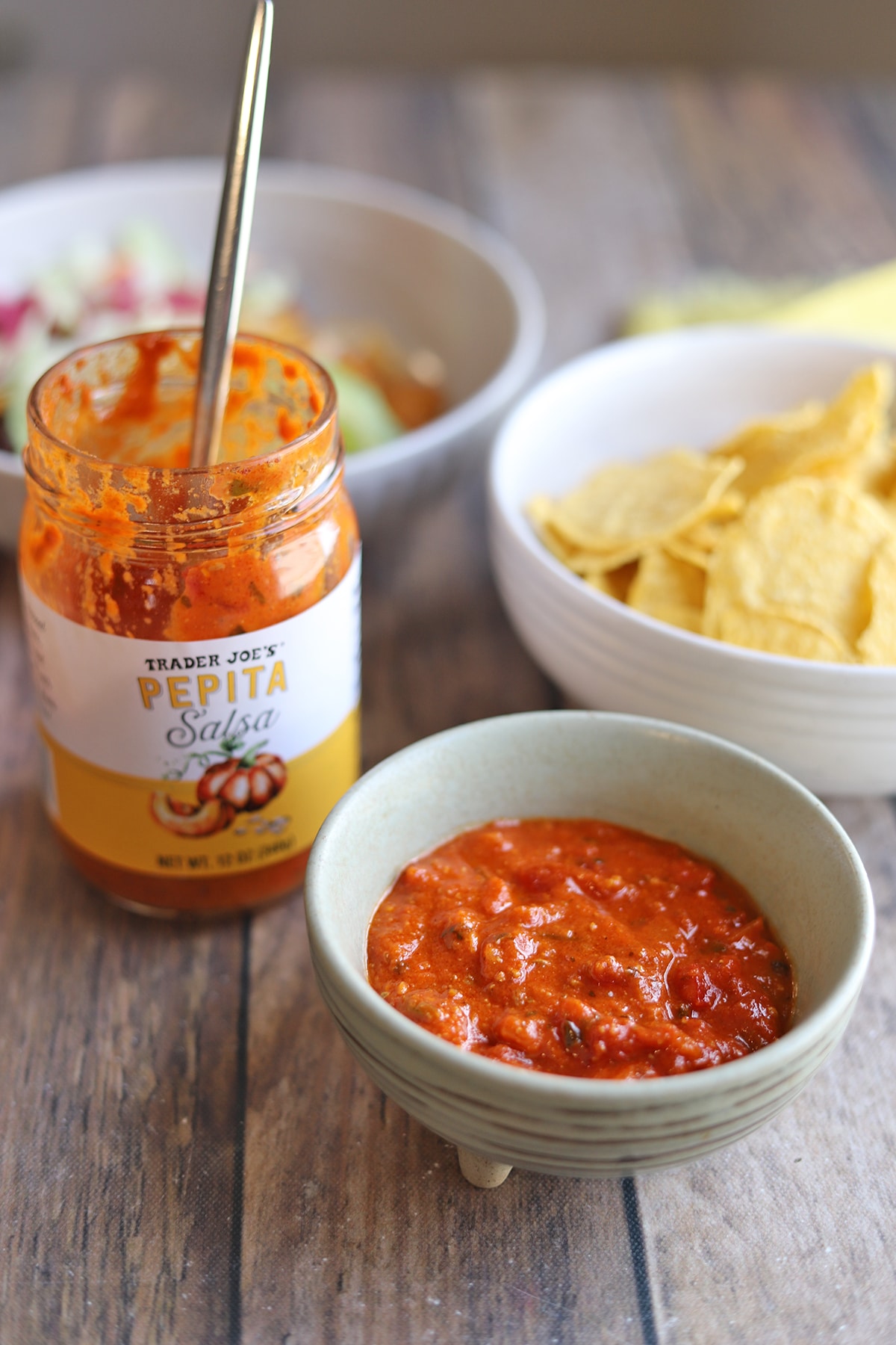 Pepita salsa with tortilla chips on table.
