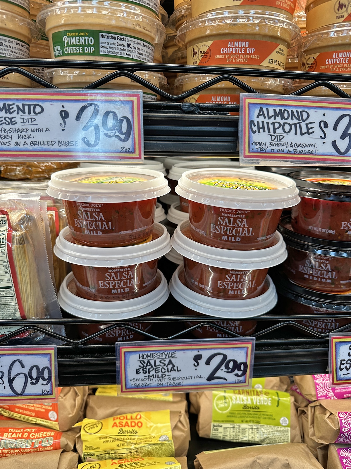Containers of salsa especial mild in refrigerated case at Trader Joe's.