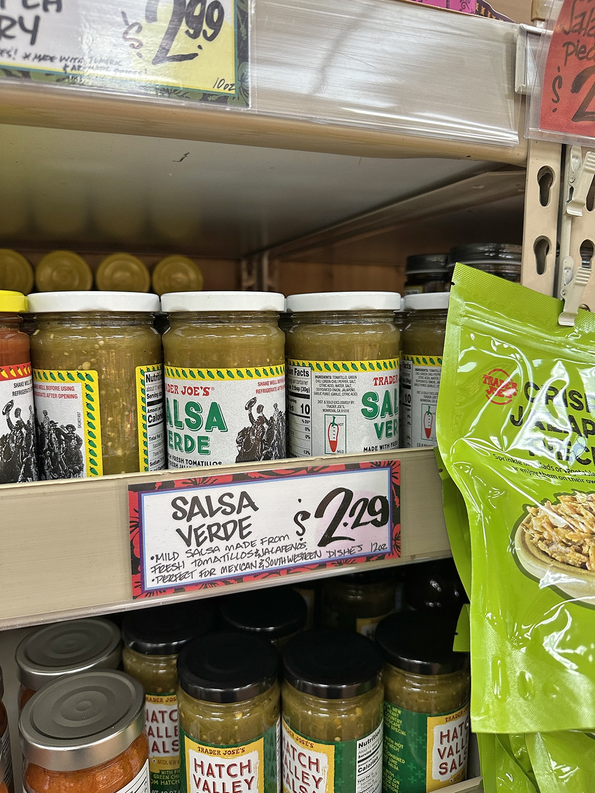 Jars of salsa verde for salt on shelves at Trader Joe's.