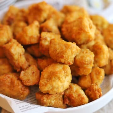 Close-up crispy breaded coating on air fryer tofu nuggets.