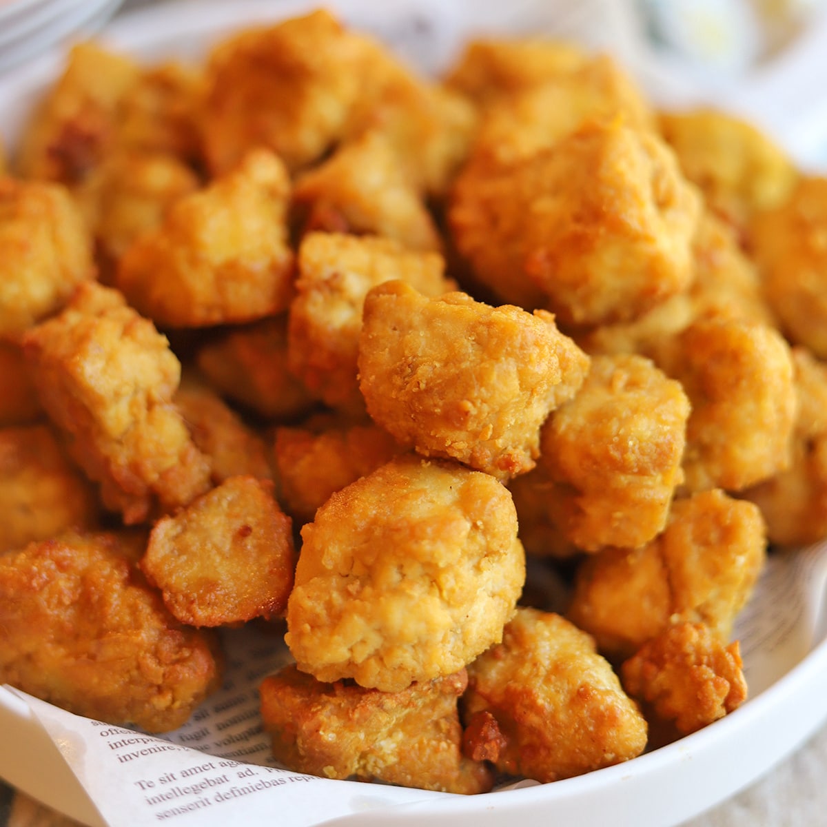 Close-up crispy breaded coating on air fryer tofu nuggets.