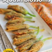 Text overlay: Vegan fried squash blossoms, cashew cheese stuffed, cadryskitchen.com. Platter of crispy squash blossoms stuffed with cashew cheese.