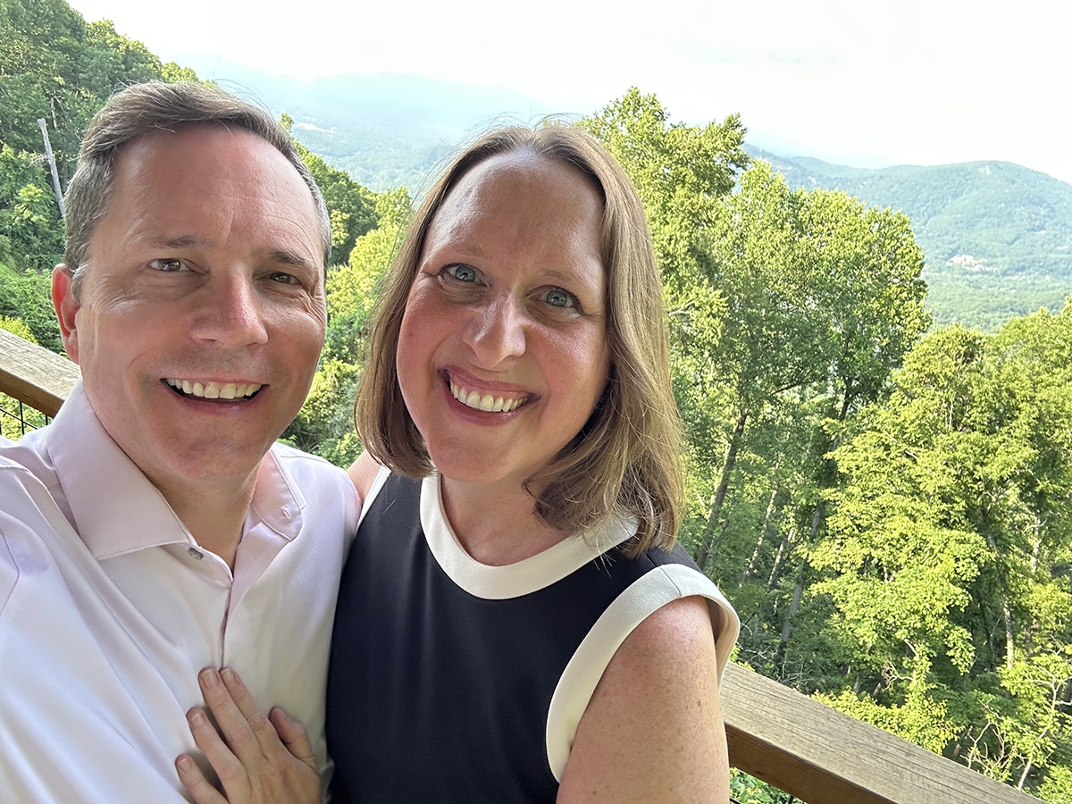 Cadry and David on a deck overlooking the Blue Ridge Mountains.