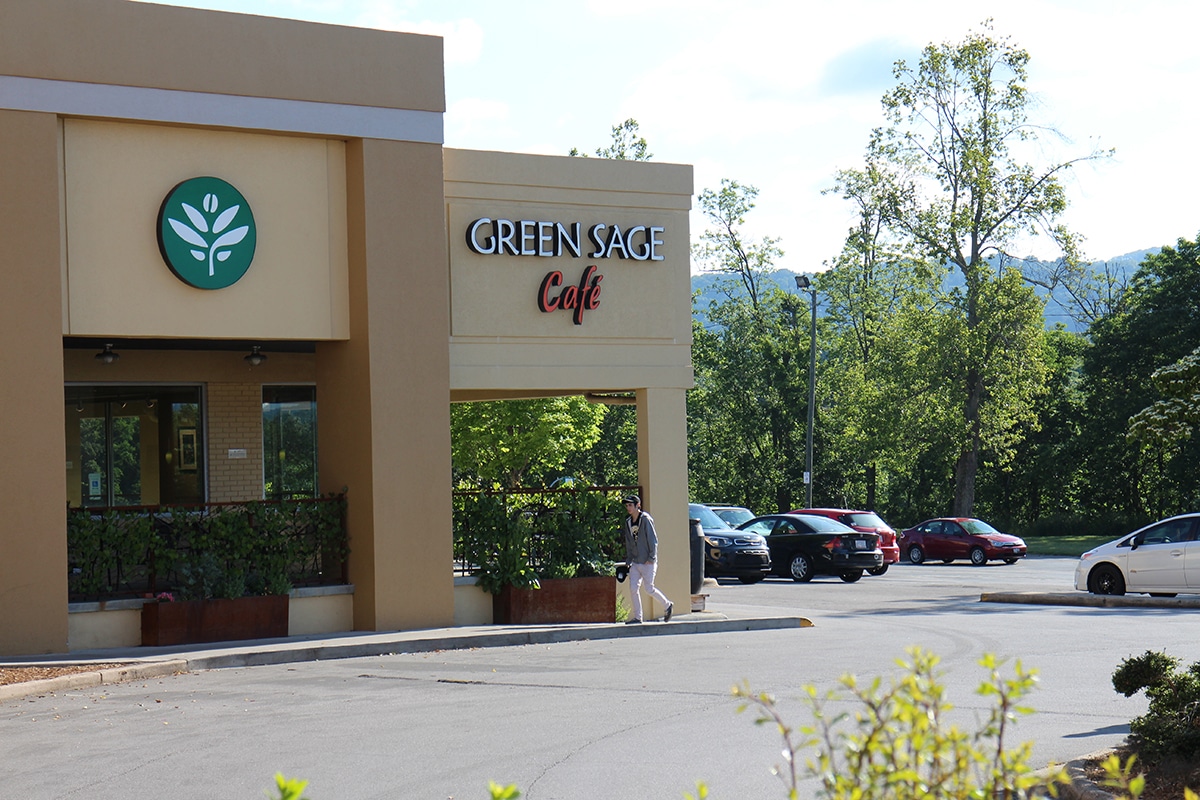 Exterior Green Sage Cafe with parking lot.