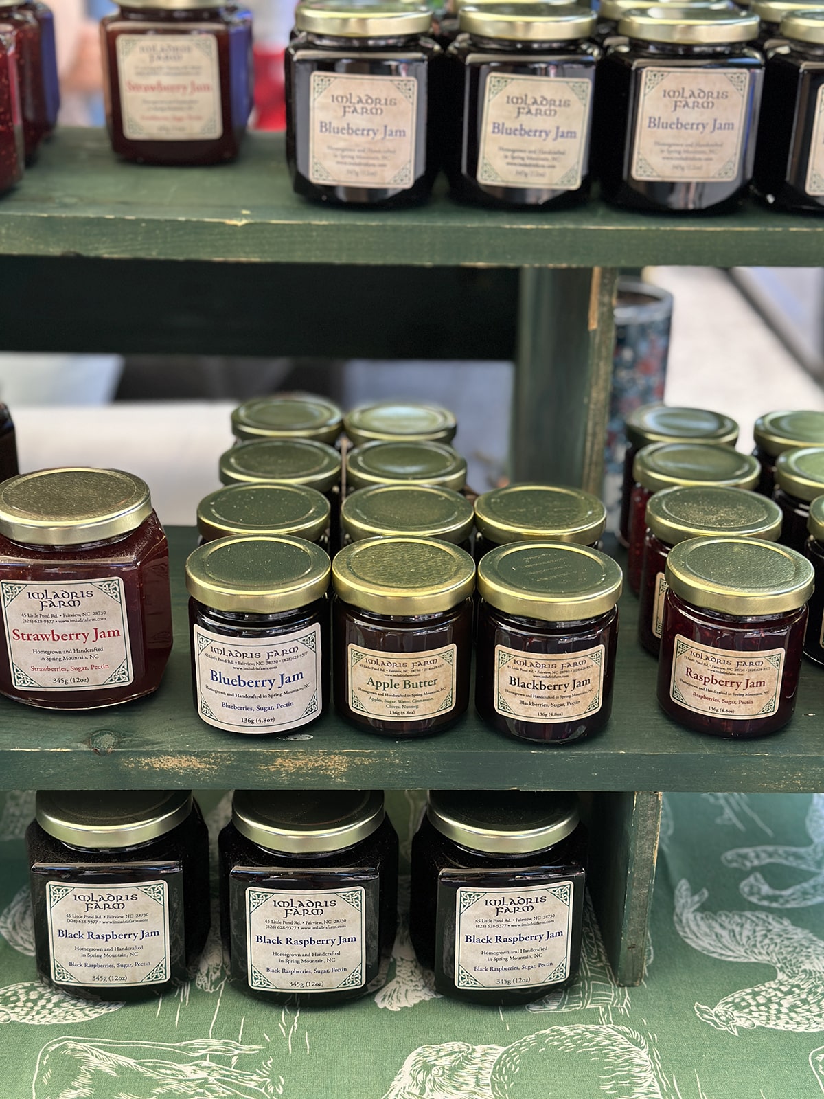 Jars of jelly on display at farmers market.