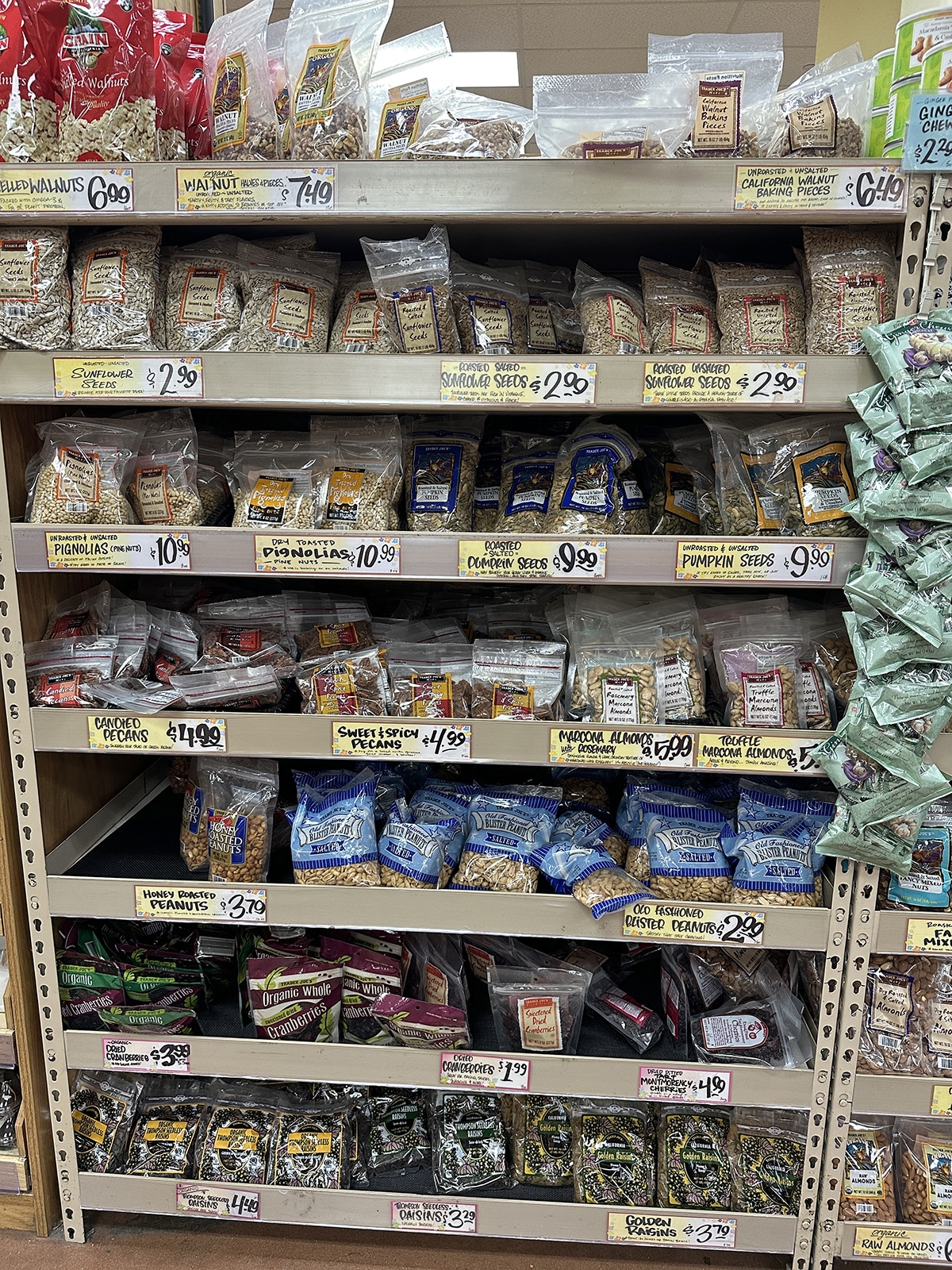 Nuts, seeds, and raisins on shelves at Trader Joe's.