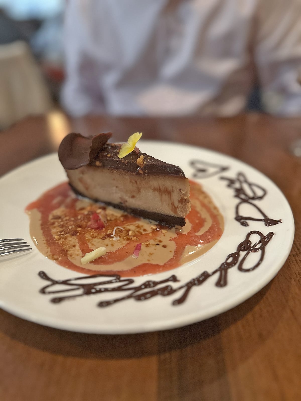 Slice of peanut butter and chocolate vegan cheesecake.
