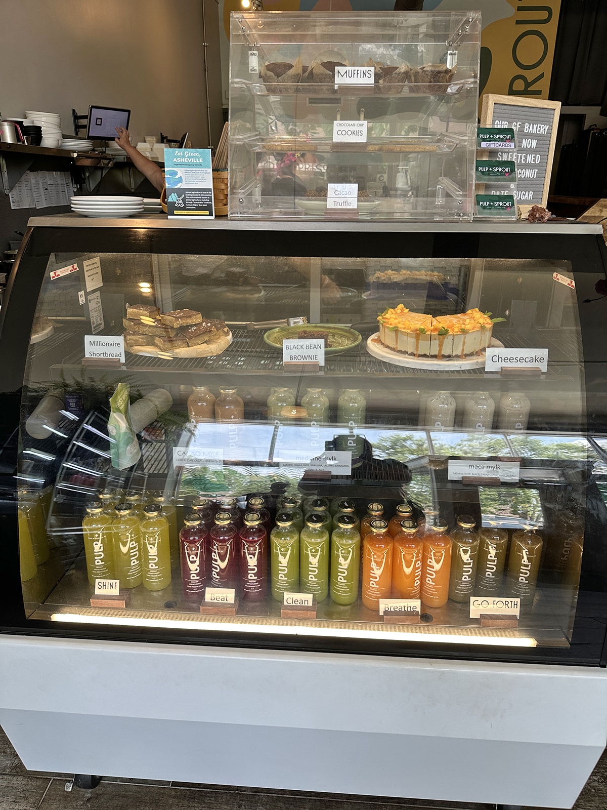 Dessert and bottled juice case at Pulp + Sprout.