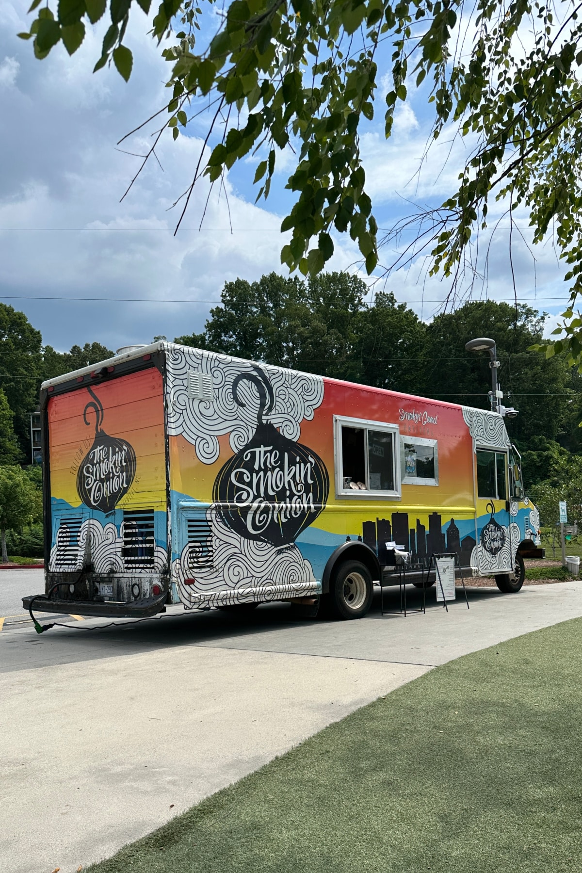 The Smokin' Onion food truck with menu sign.