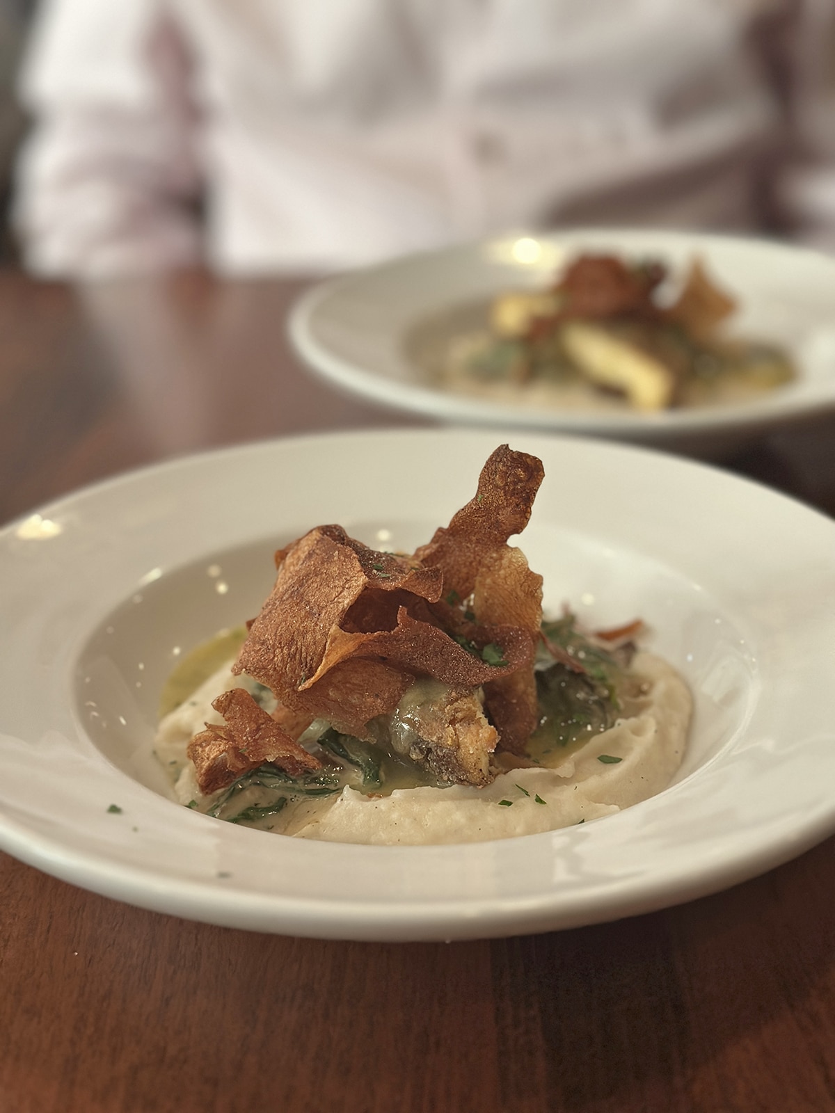 Tofu piccata over mashed potatoes and topped with crispy potato skins.