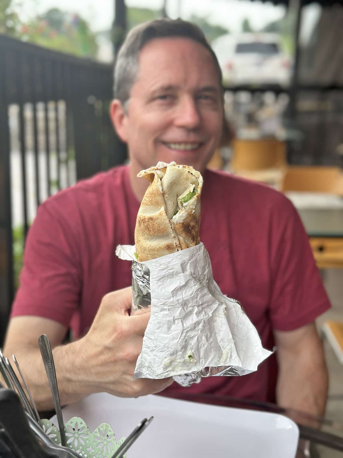 David holding vegan "not lamb" shawarma wrap.