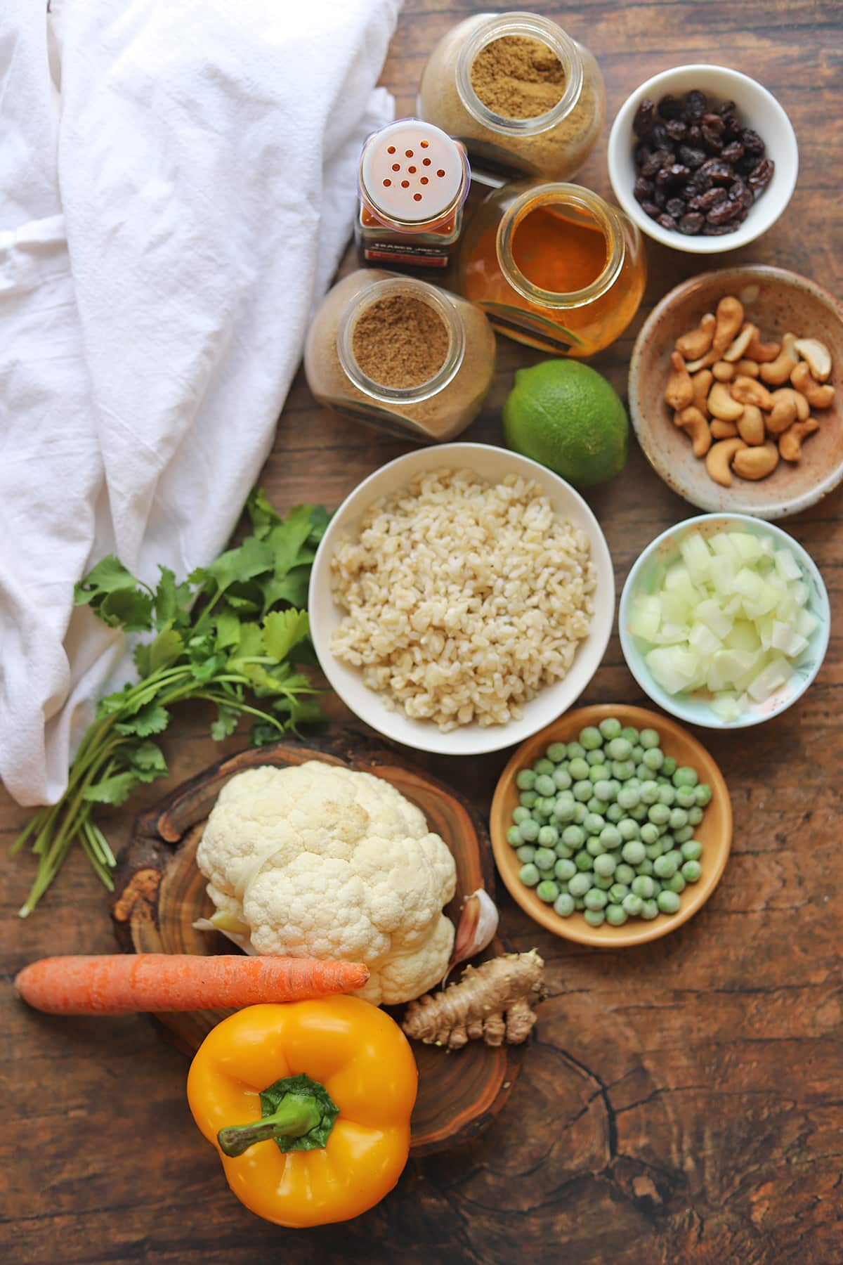 Ingredients for vegetable fried rice on table - including a ginger root.