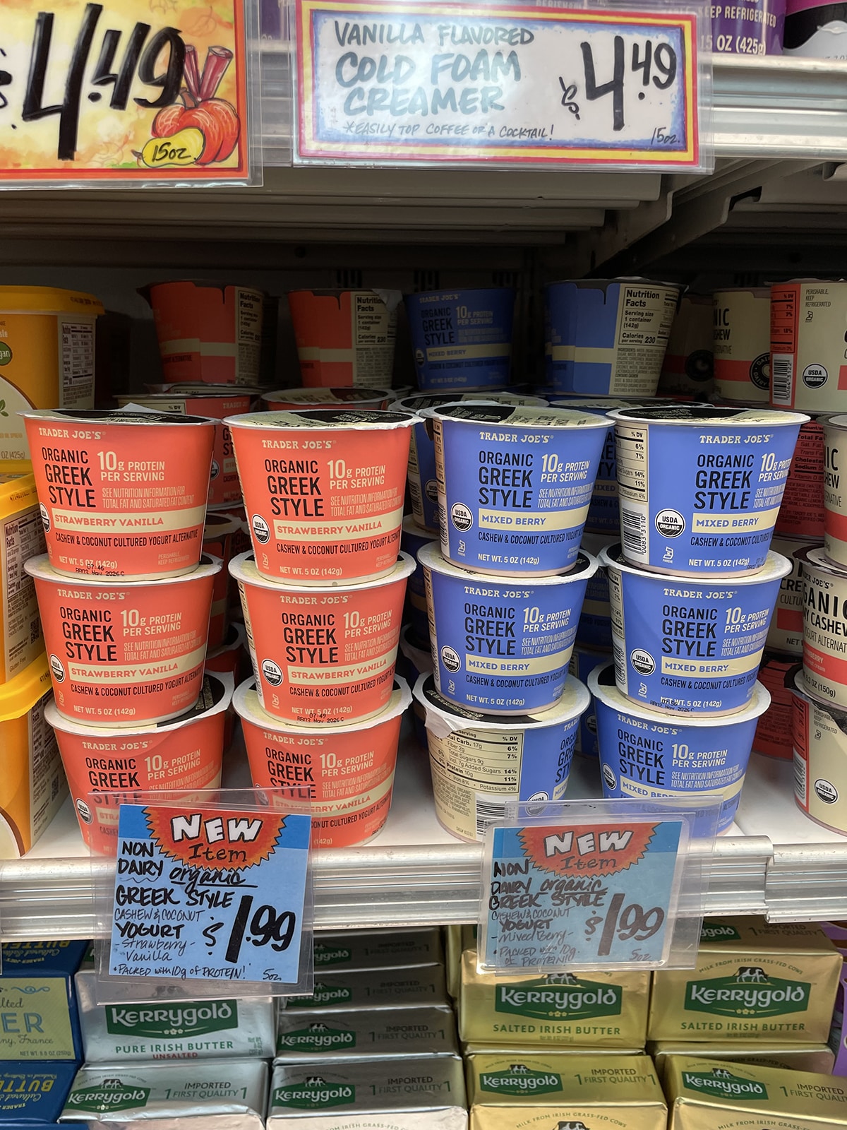 Trader Joe's non-dairy Greek style yogurt in strawberry vanilla and mixed berry on refrigerated display.
