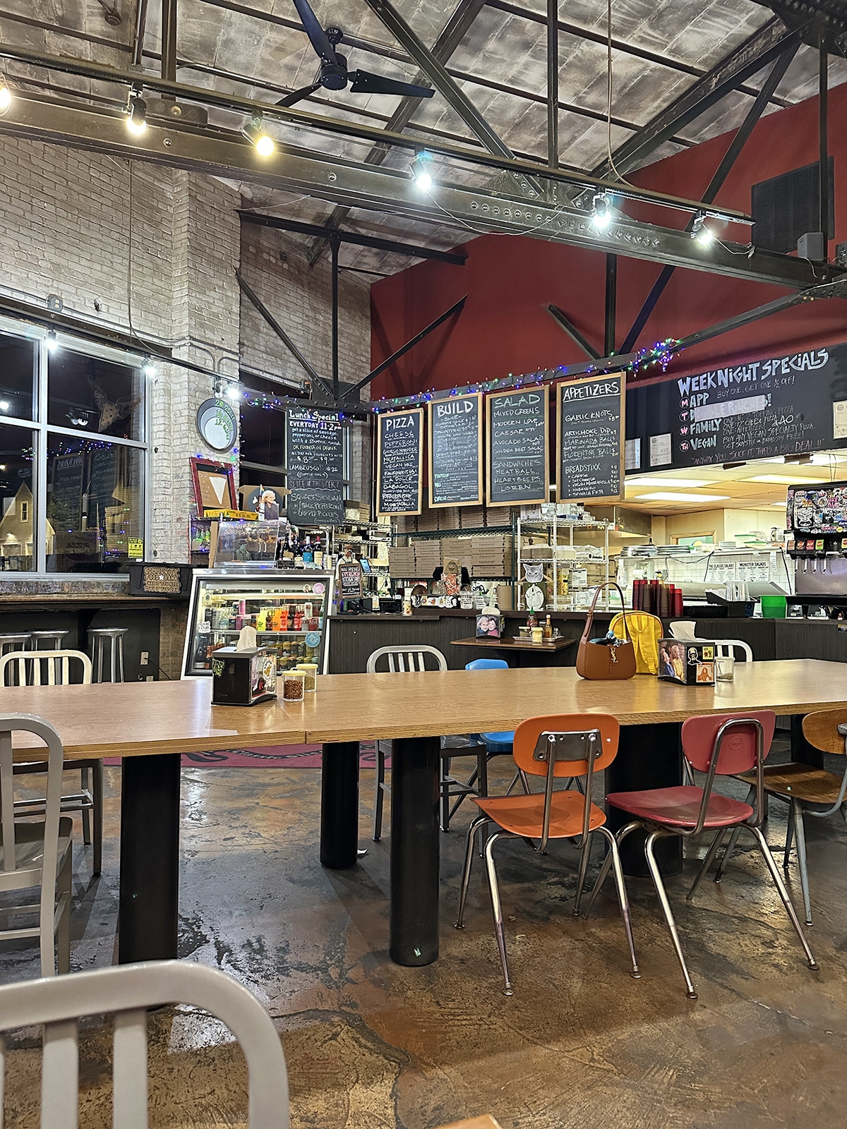 Menu board and tables at Classic Slice, a casual pizza place in Milwaukee, Wisconsin.