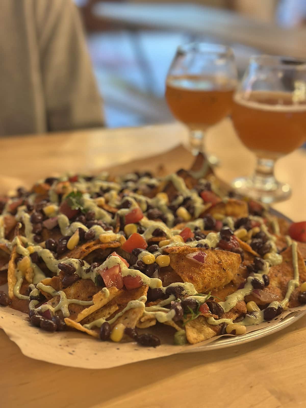 Vegan nachos with beans and corn, plus two glasses of beer at Dead Bird Brewing.