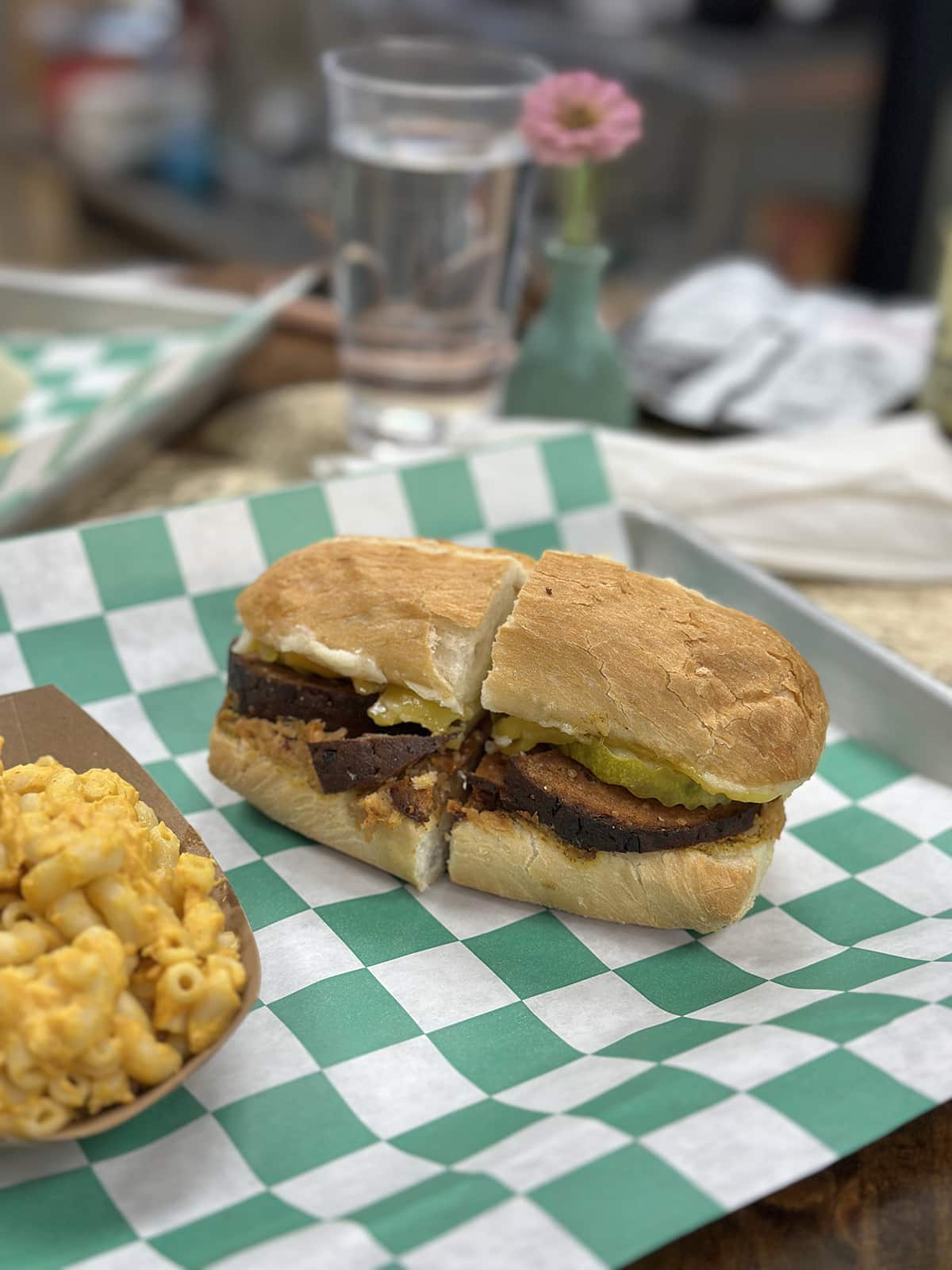 Cubano sandwich with seitan ham and pickles on roll.