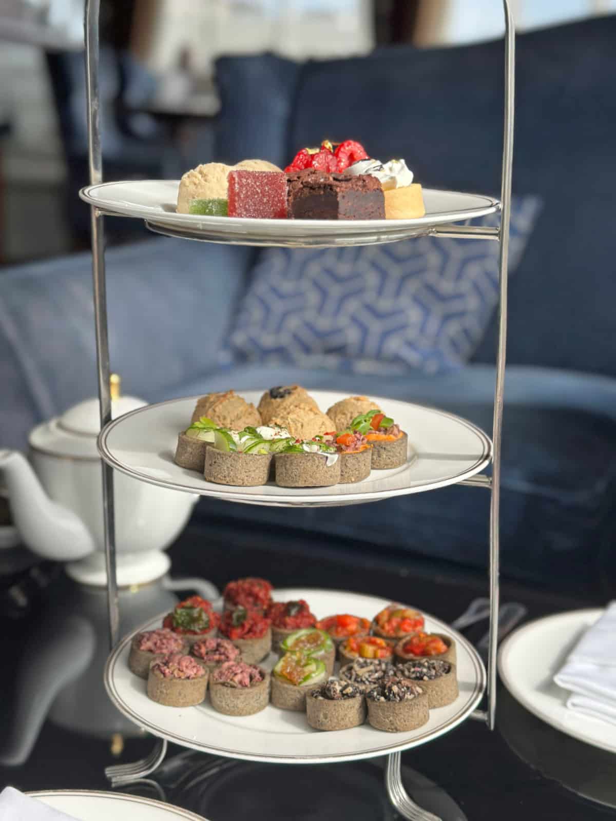 Stacked plates of vegan sweets, tarts, and scones at Pfister Hotel afternoon tea.