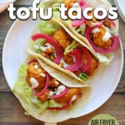 Text overlay: Buffalo tofu tacos, air fryer, pan-fried, or baked, cadryskitchen.com. Platter of crispy tofu tacos with buffalo sauce.