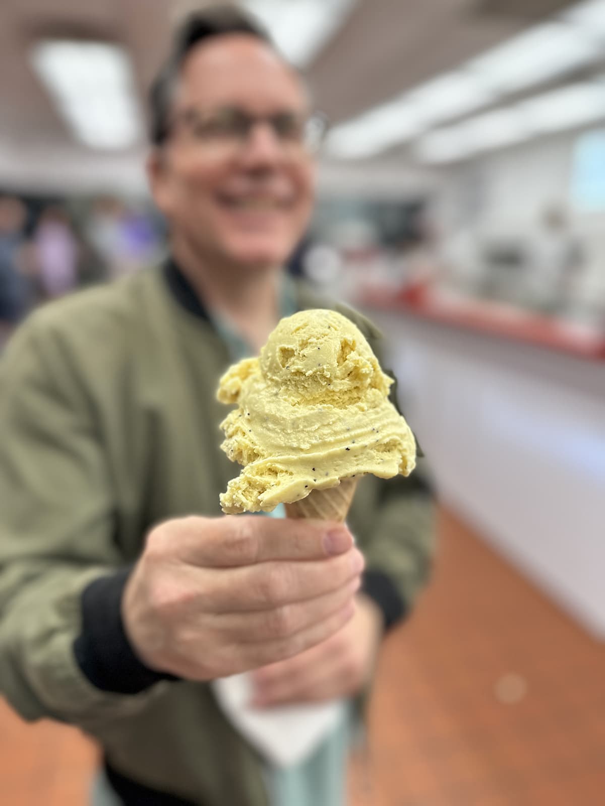 David holding lemon poppy seed sugar cone at Whitey's.